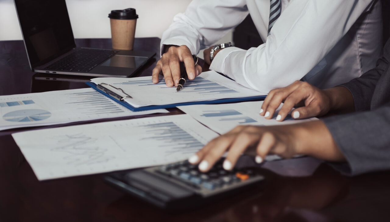 businessmen and businesswomen team meeting to plan strategies to increase business income. Have a brainstorming graph analysis and discussing for the new target success.